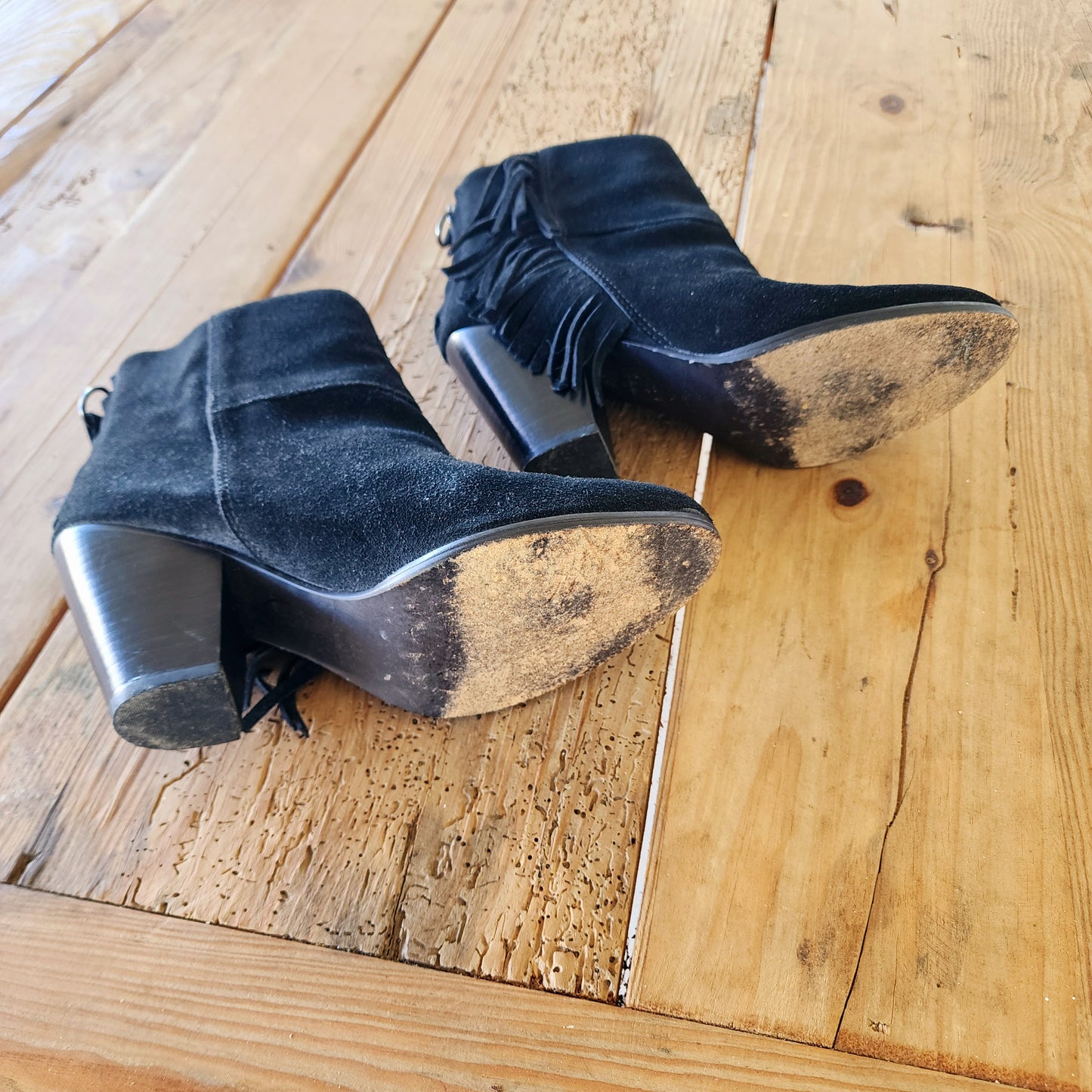 Bottom view of the Ash fringe suede boots, showing the signs of wear on the bottom of the boots and heel