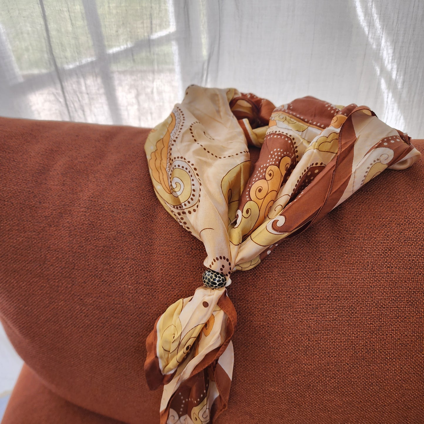 image showing the dalmation print clip on earrings styled on a scarf