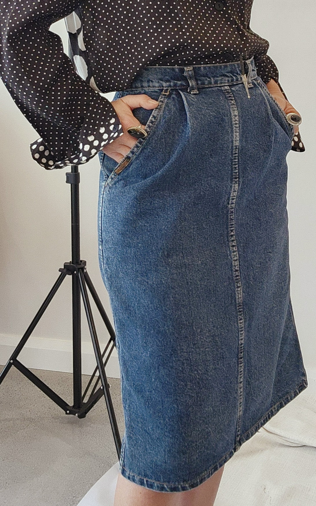 Knee length denim skirt by Faberge. Vintage 80's style with pockets, pleats & belt loops in a size 8. Online now at Wilson Avenue