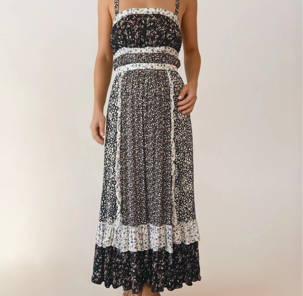 Front view of a model wearing the Free People mixed floral and frill picnic style maxi dress