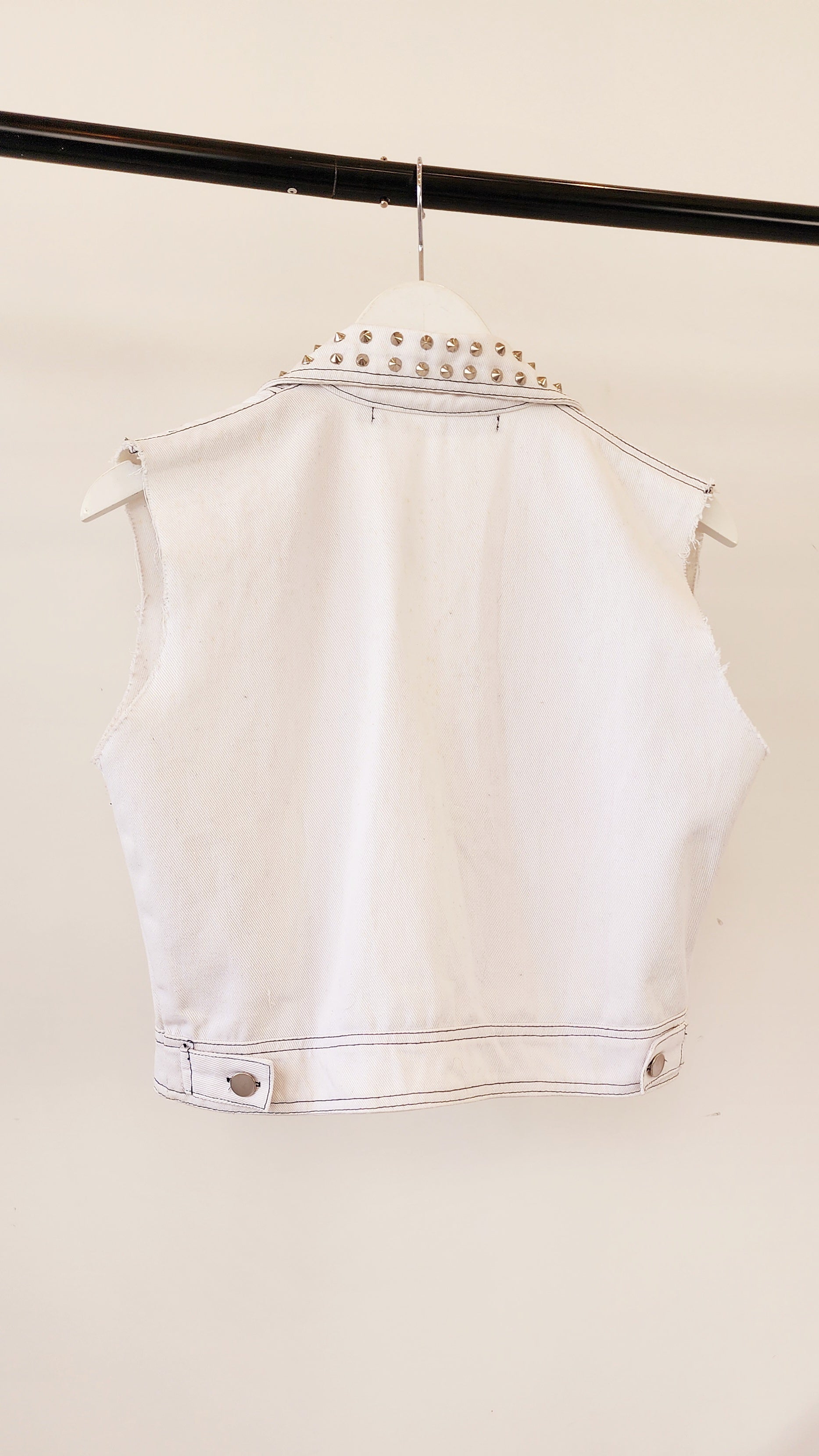 Back view of the Jamie Fame studded vest, showing waistline buttons and studded collar details.