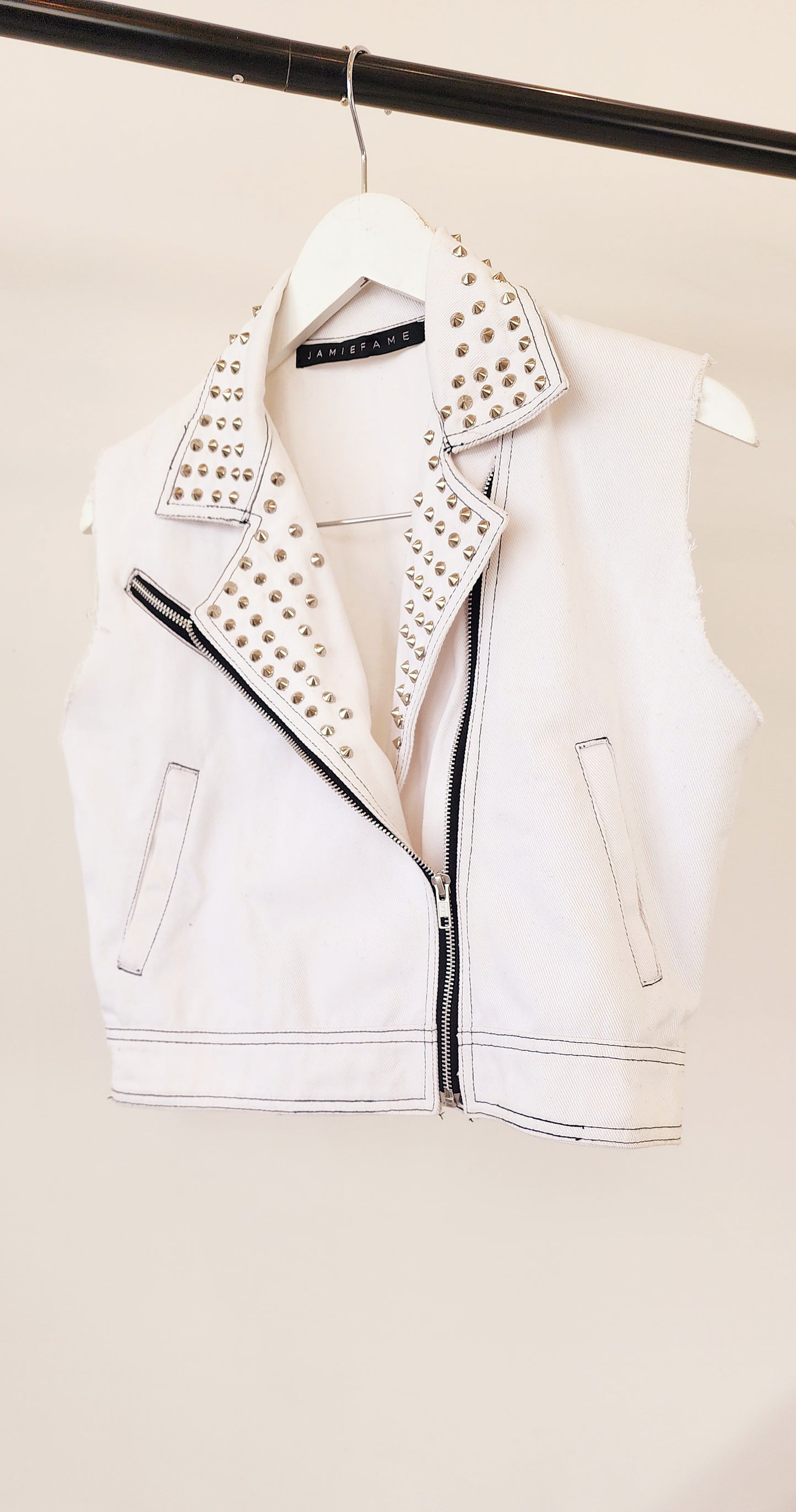 Hanging view of Jamie Fame studded vest, showing pockets, zip and stud details.