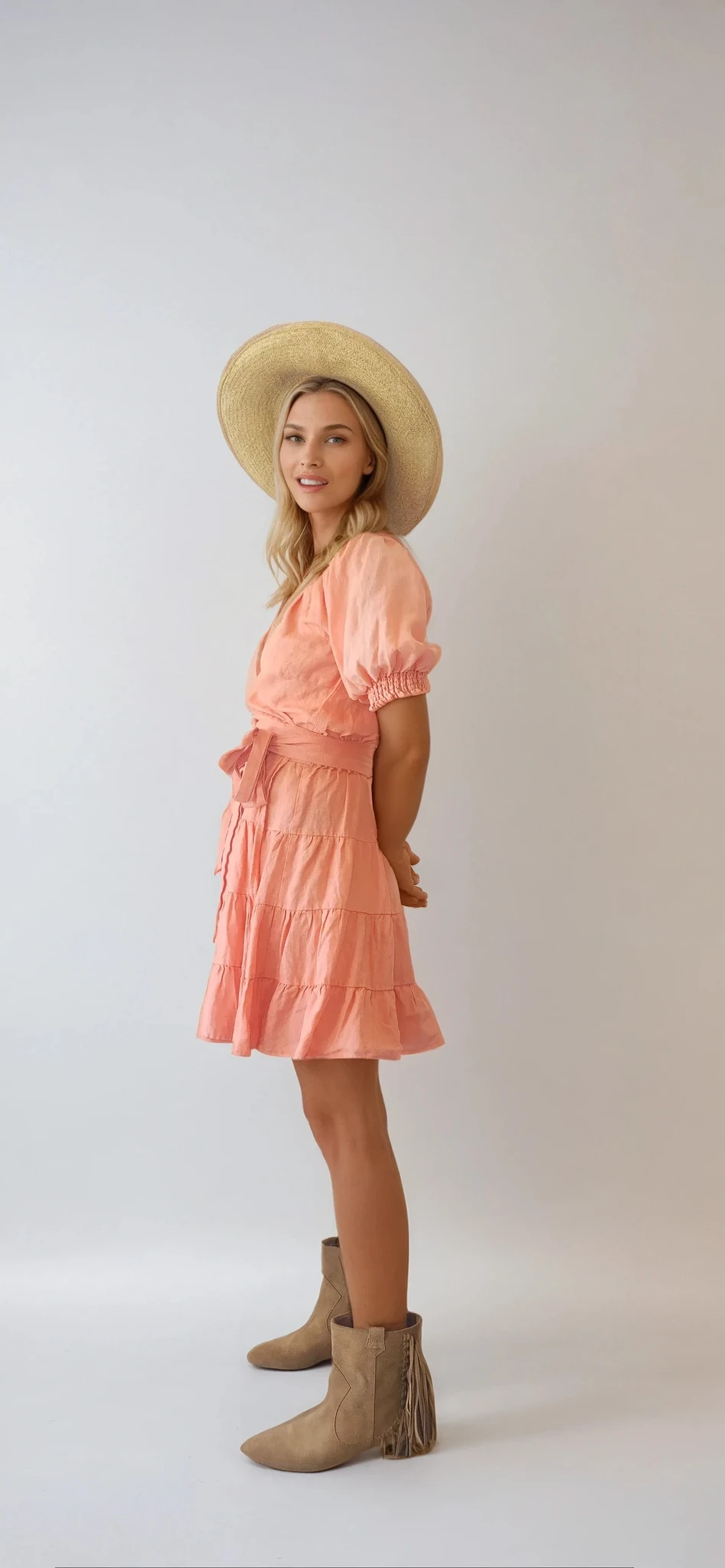 Kivari Alice tiered wrap mini dress in size 12. Salmon pink colour with a tie waist and puff sleeves. Available at Wilson Avenue