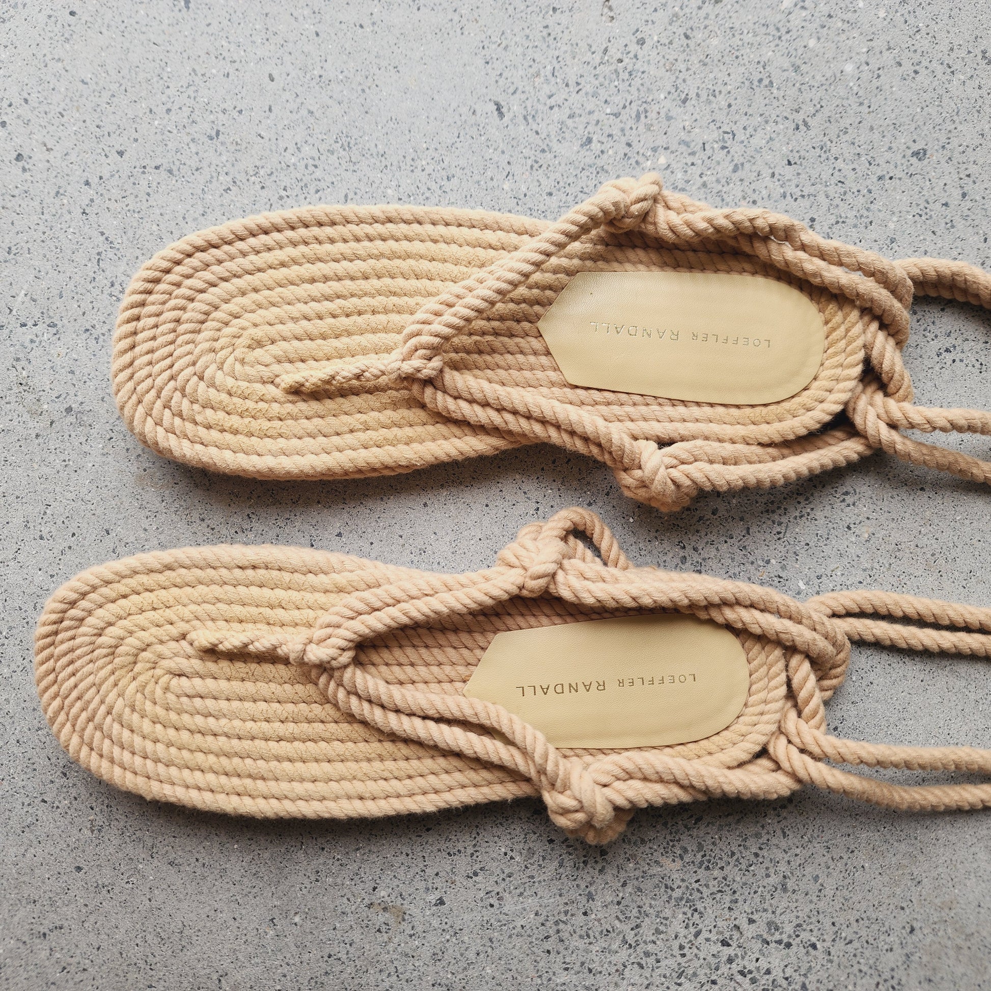 Close up top view of Loeffler Randall rope sandals, showing the label.