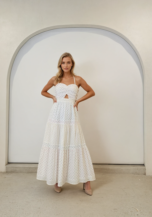 Front view of Marlo Yazmin dress, showing cut out front, flare and tiered style. Worn by a model with hands on hips