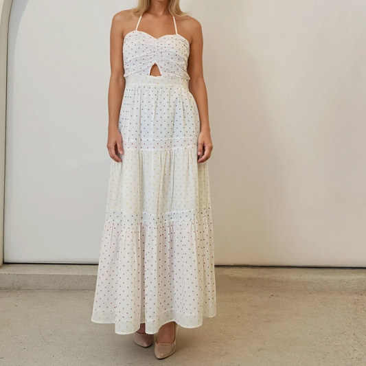 Front view of Model wearing the Marlo Mummy, multicoloured polka dot maxi dress, showing the halter neck style and ruched bust.