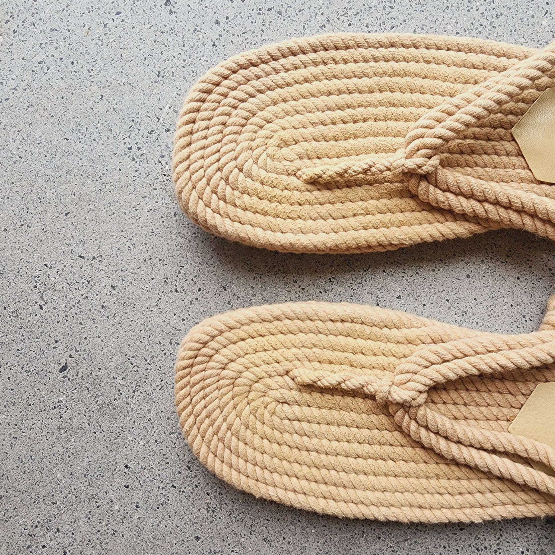 A close-up view of the top toe area of the Loeffler Randall rope sandals, showing minor signs of wear.