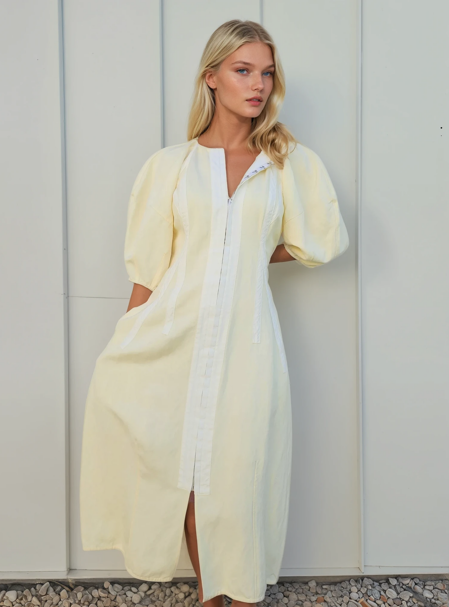 Model wearing the Oroton sculptured dress, showing the puff sleeves and hook and eye front closure.