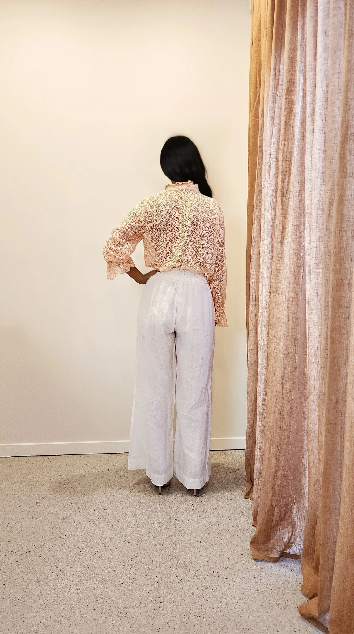 Full back view of the lace blouse, revealing the lightness of the fabric and flattering fit from behind.