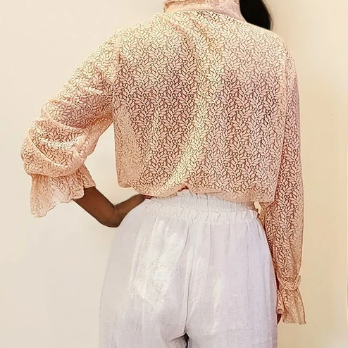 Full back view of the lace blouse, revealing the lightness of the fabric and flattering fit from behind.