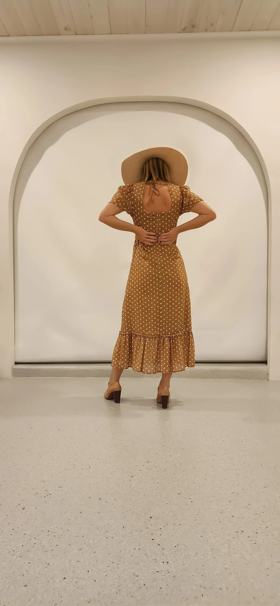 Back view of the Ownley Vera dress with zip up back and midi-length drape.