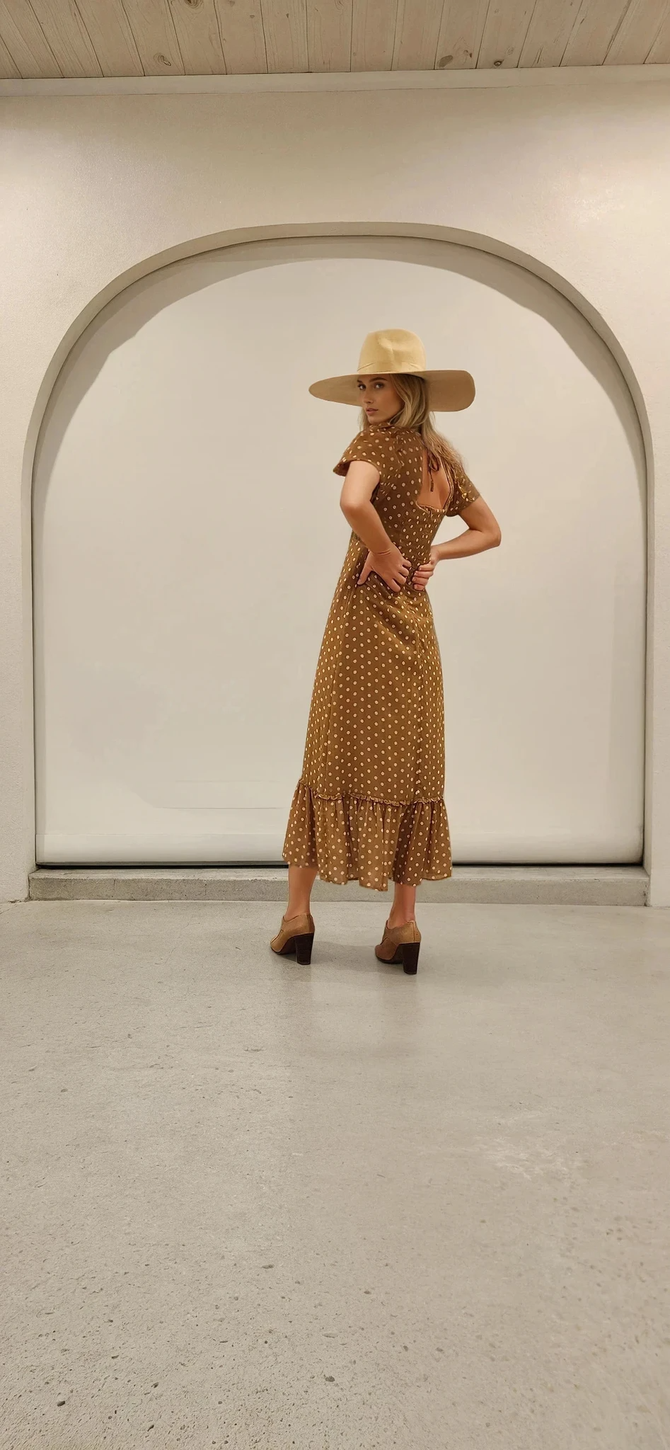 Side view of the Ownley Vera midi dress showing the flattering silhouette and subtle ruffle hem.