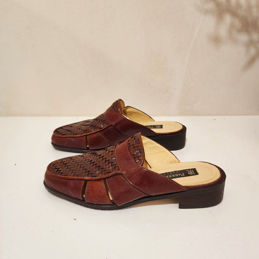 Side view of the Parker Roche leather mules, showing the woven detail and side panels.