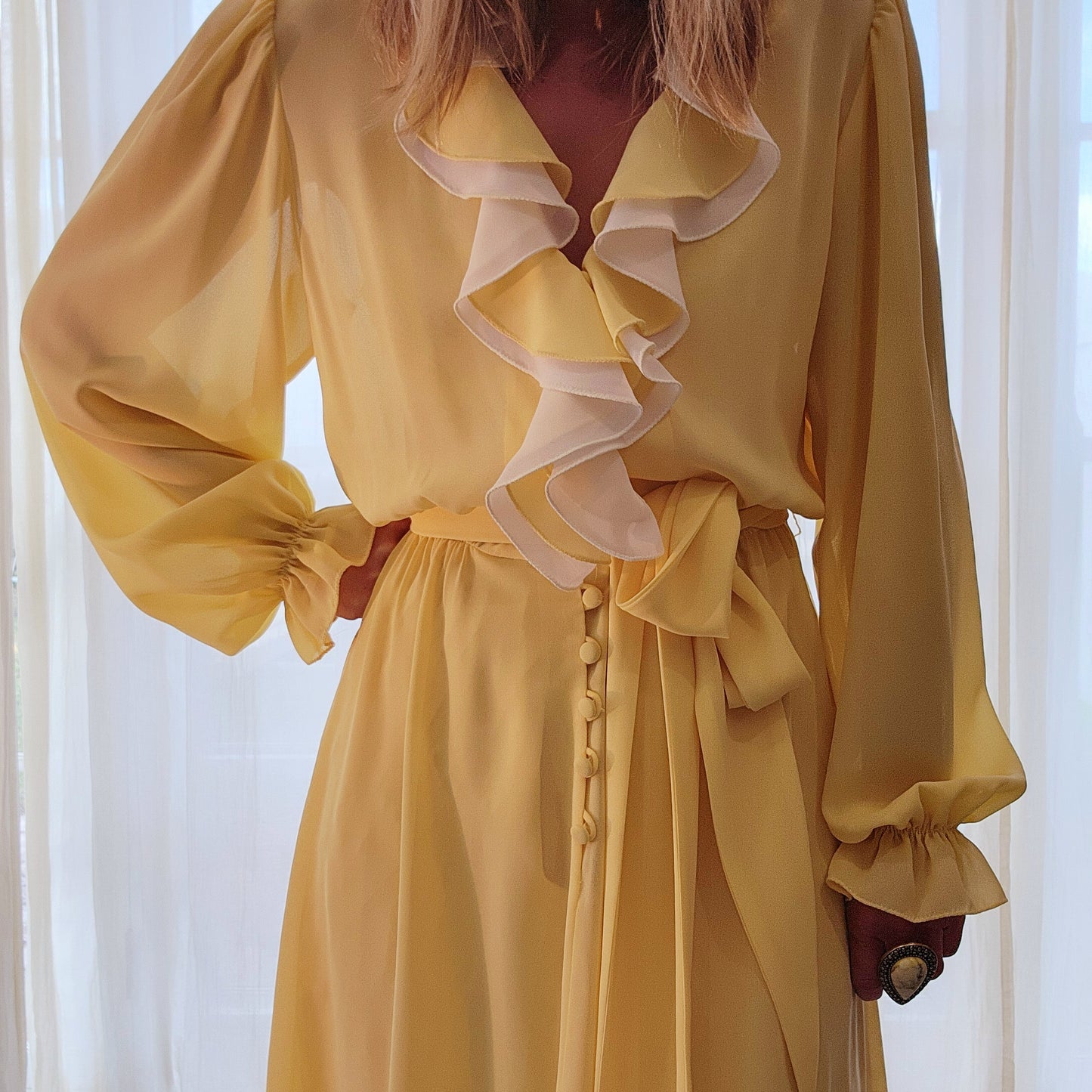 Vintage Peter Barron Ruffle neck dress in lemon and white, it is in a semi-sheer fabric with a button up front and tie belt. Available in a size 12 at Wilson Avenue
