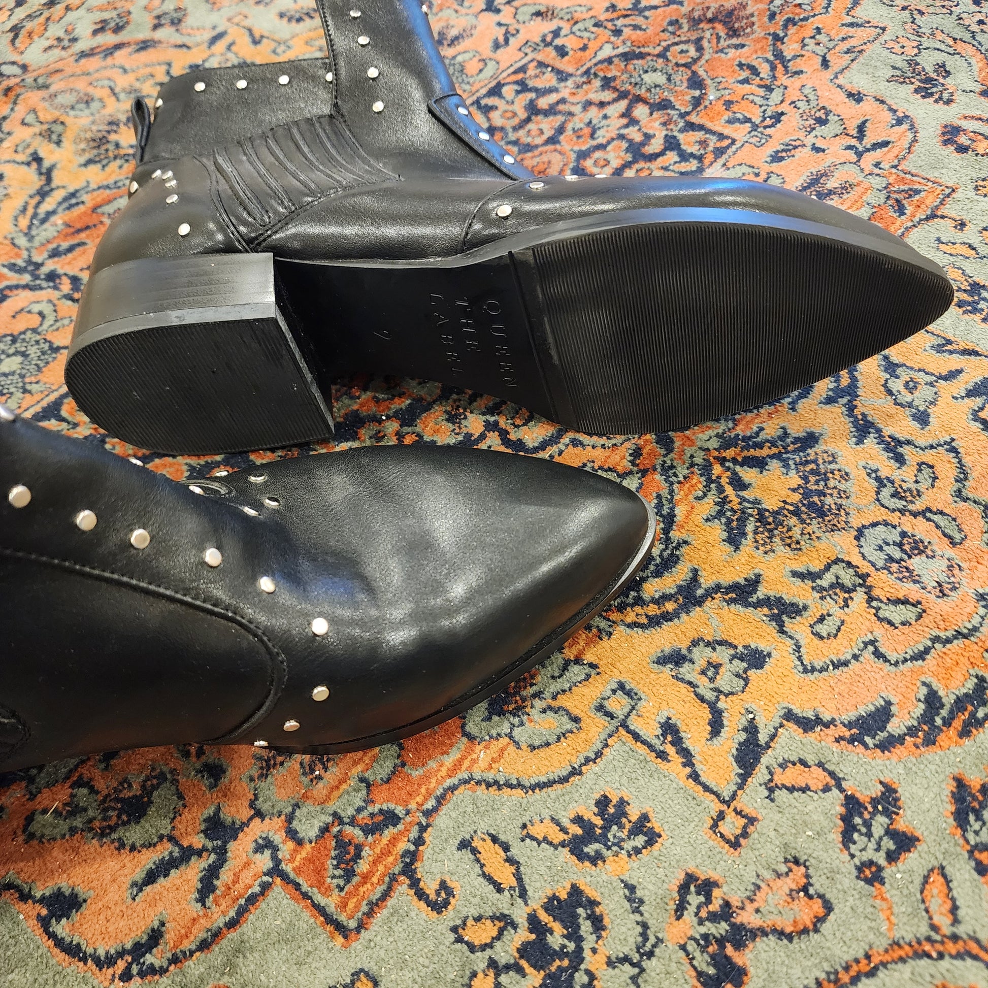 Bottom view of Queen the label studded boots showing new condition.