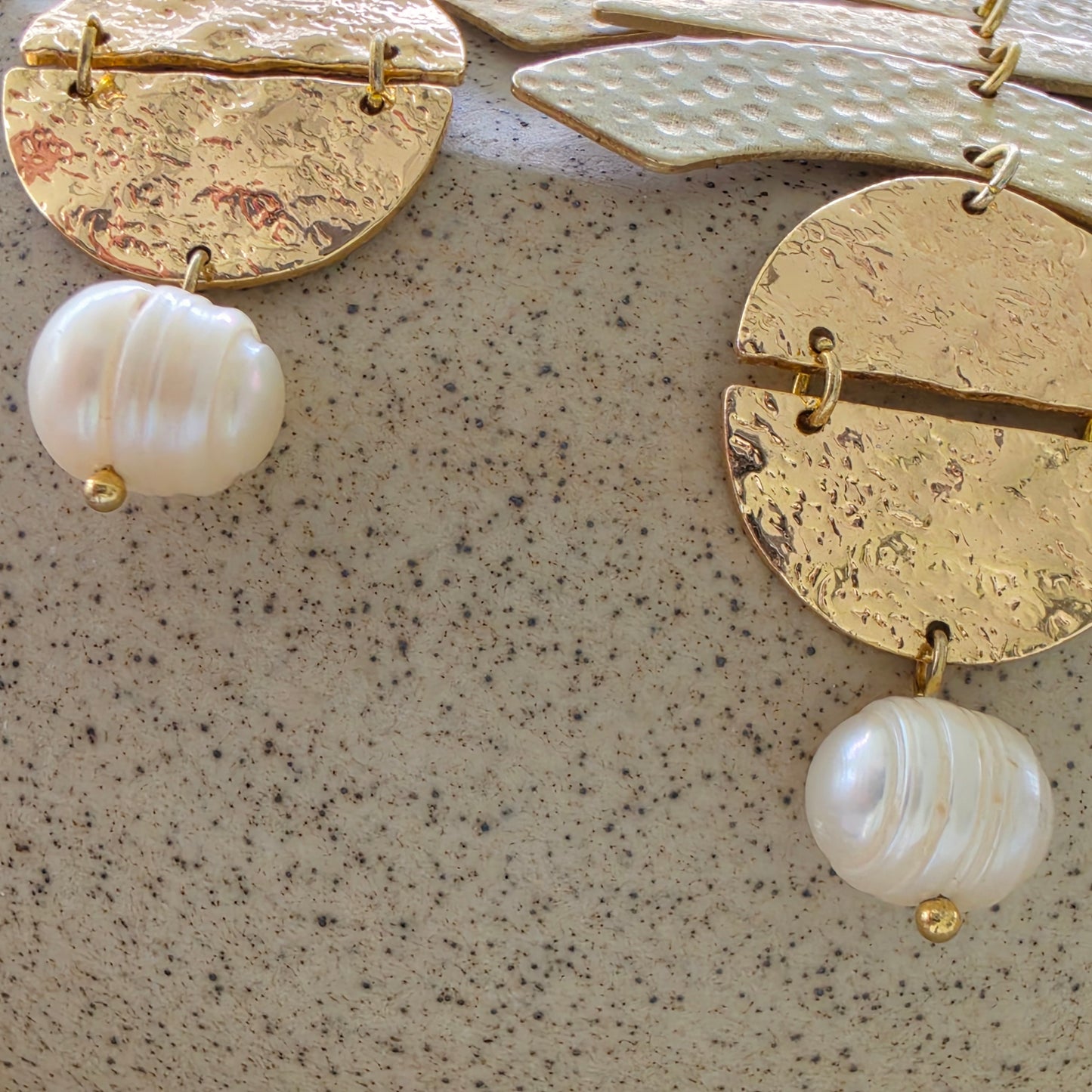 Close up view of the pearls on the Skupiti handmade earrings