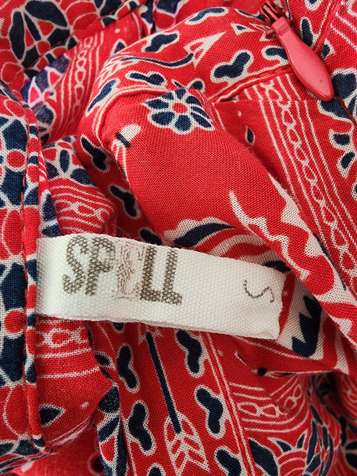 Close up of the spell label tag on red gypsiana skirt