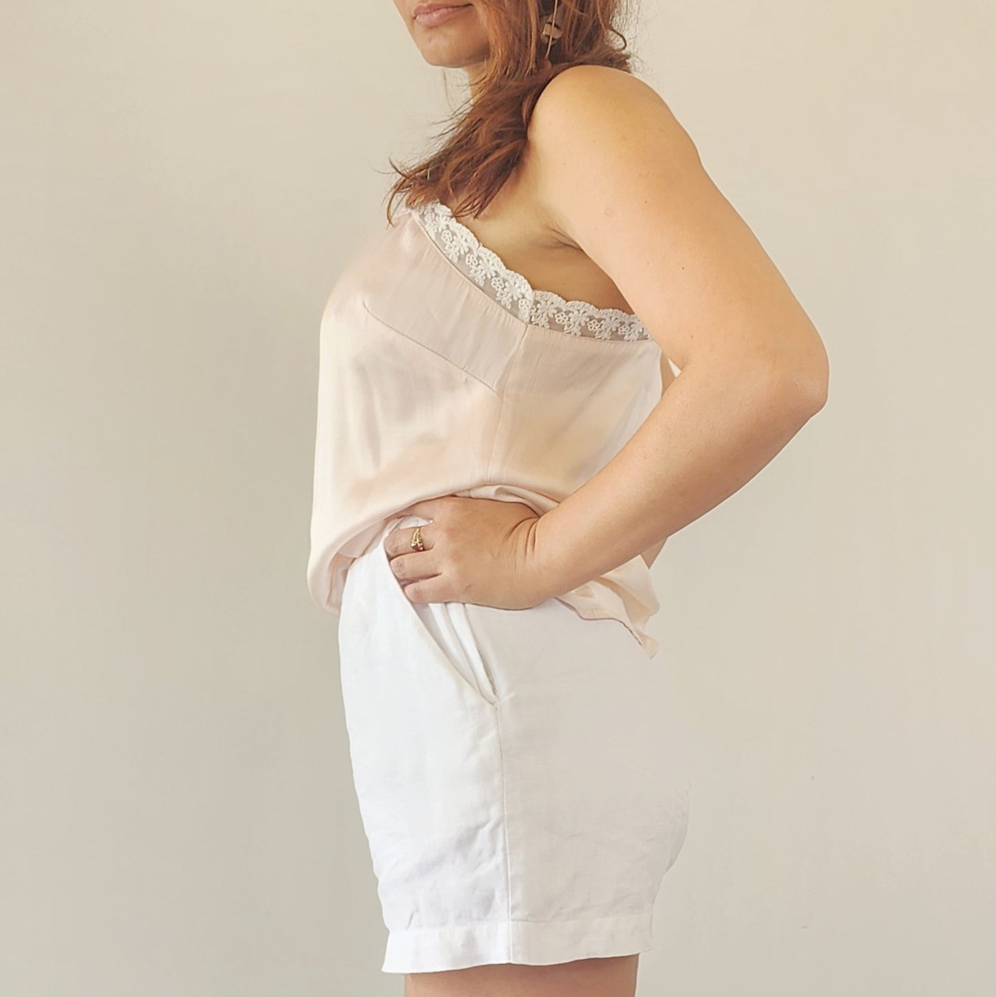 Close up view of the St Agni white linen shorts, showing their simple design and pocket.