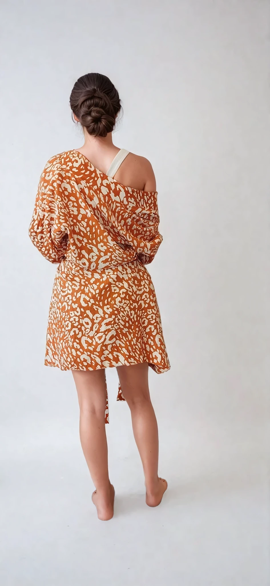 Model showing the back view of The Travelling Kimono mid length kimono, showing the natural relaxed fall of the linen.