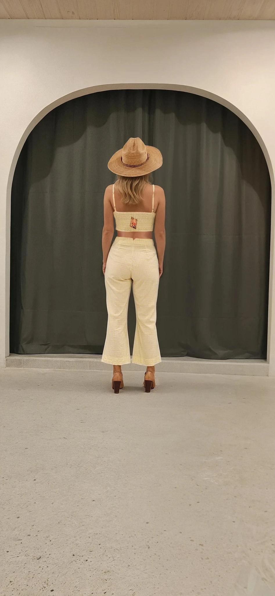 Model wearing yellow gingham Tigerlily Tippi Pants, Showing the cropped style and flared cut.
