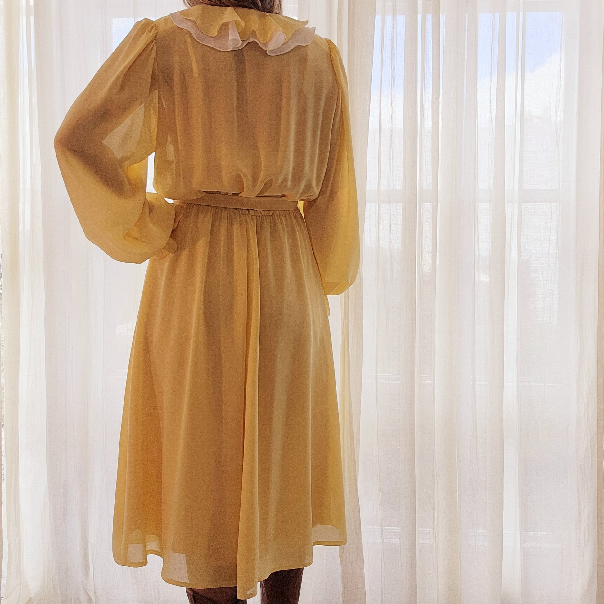 Lemon yellow semi-sheer Vintage Peter Barron dress in a size 12. This dress has a white & Yellow ruffle neckline and a fabric tie belt. Available online now at Wilsonavenue.au