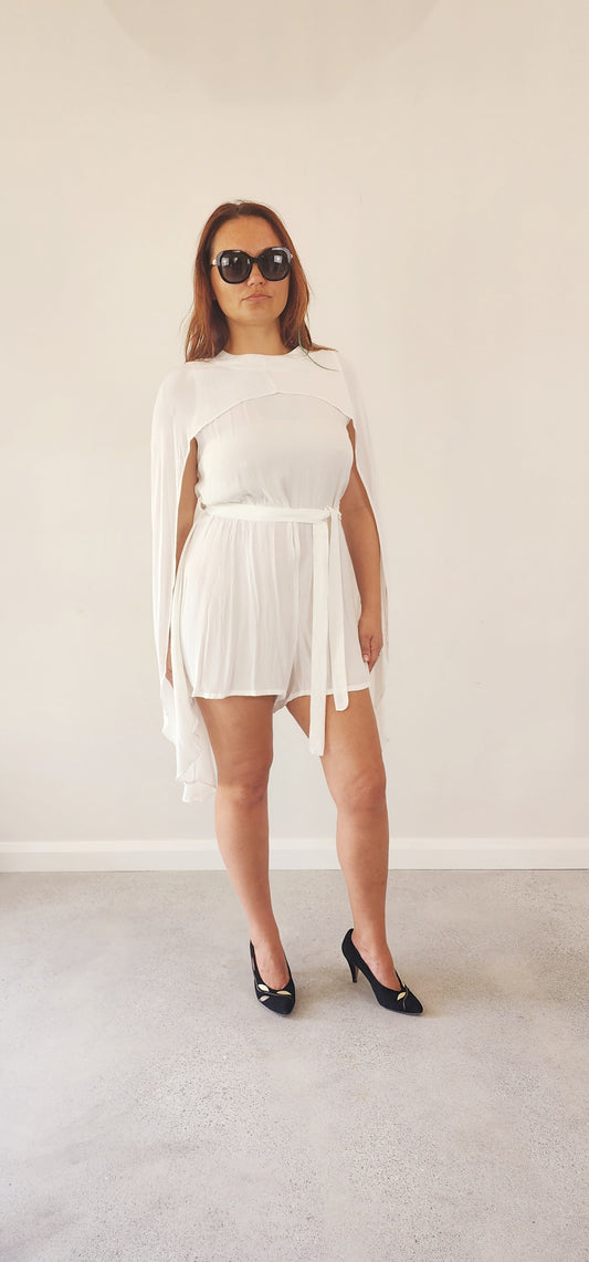 Womens white cape style, flare sleeved playsuit in size 12 by Australian designer Incyda