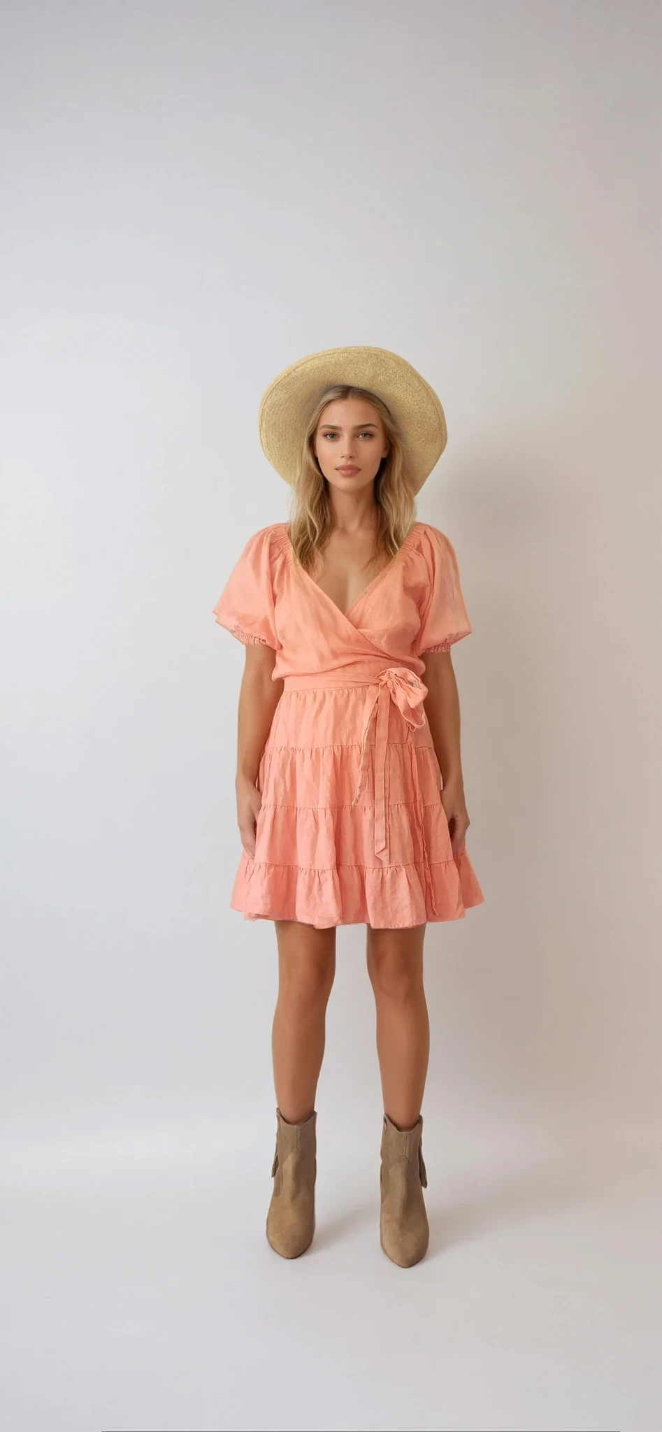 Kivari Alice linen tiered wrap mini dress in size 12. Salmon pink colour with a tie waist and puff sleeves. Available at Wilson Avenue