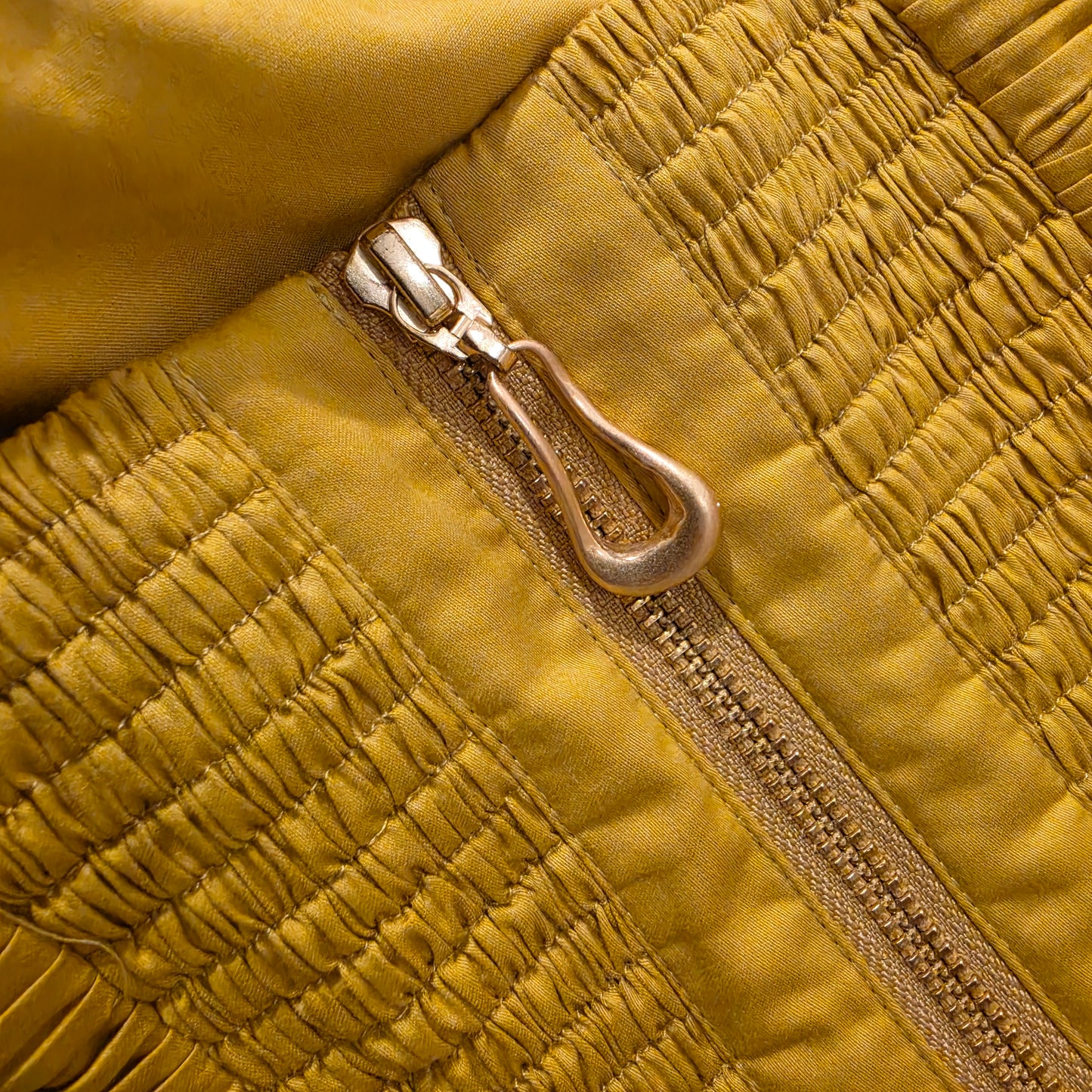 Close-up detail of shirred back panel and zip on Aje Marigold dress