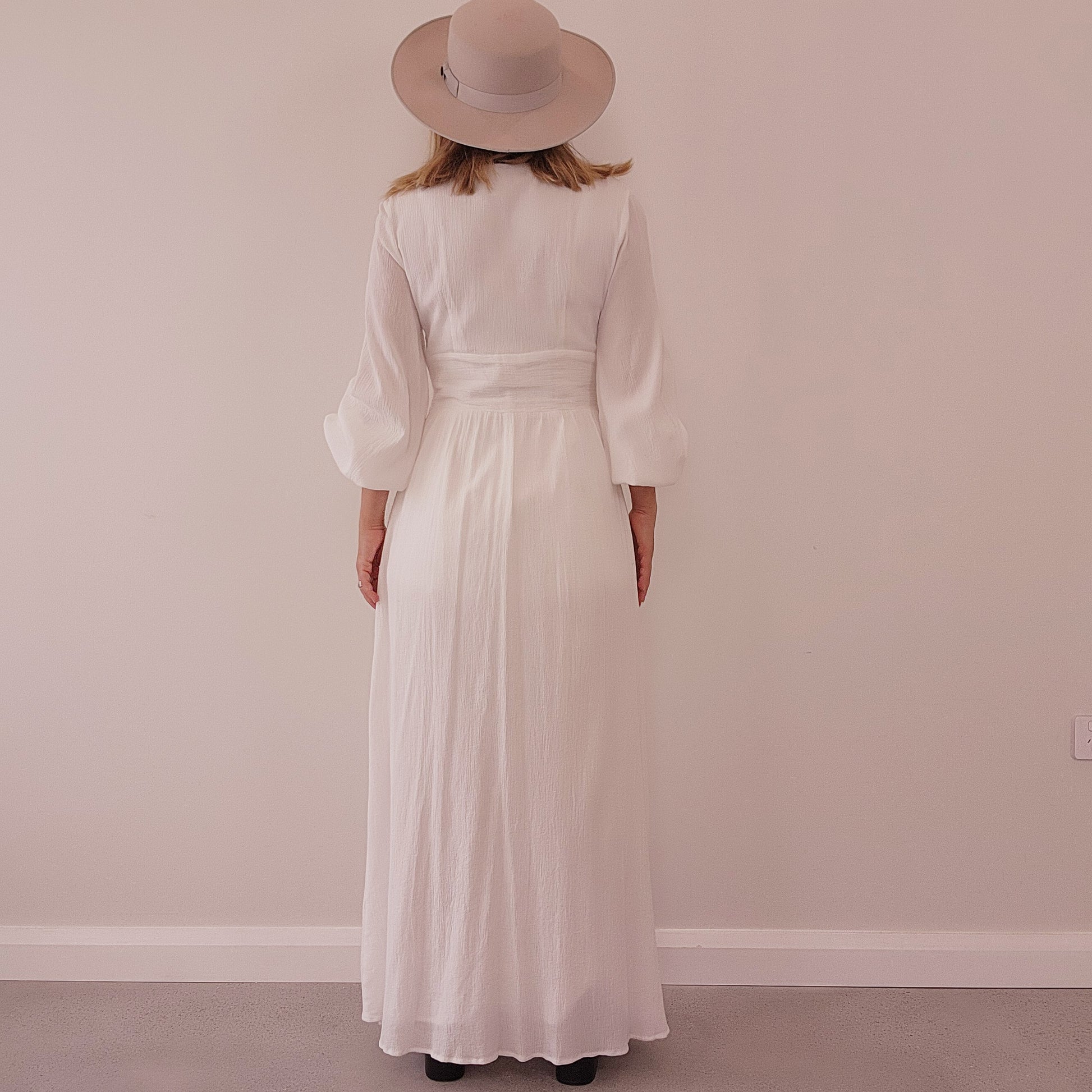 Back of white Charlie Holiday maxi dress with relaxed silhouette and full length hem