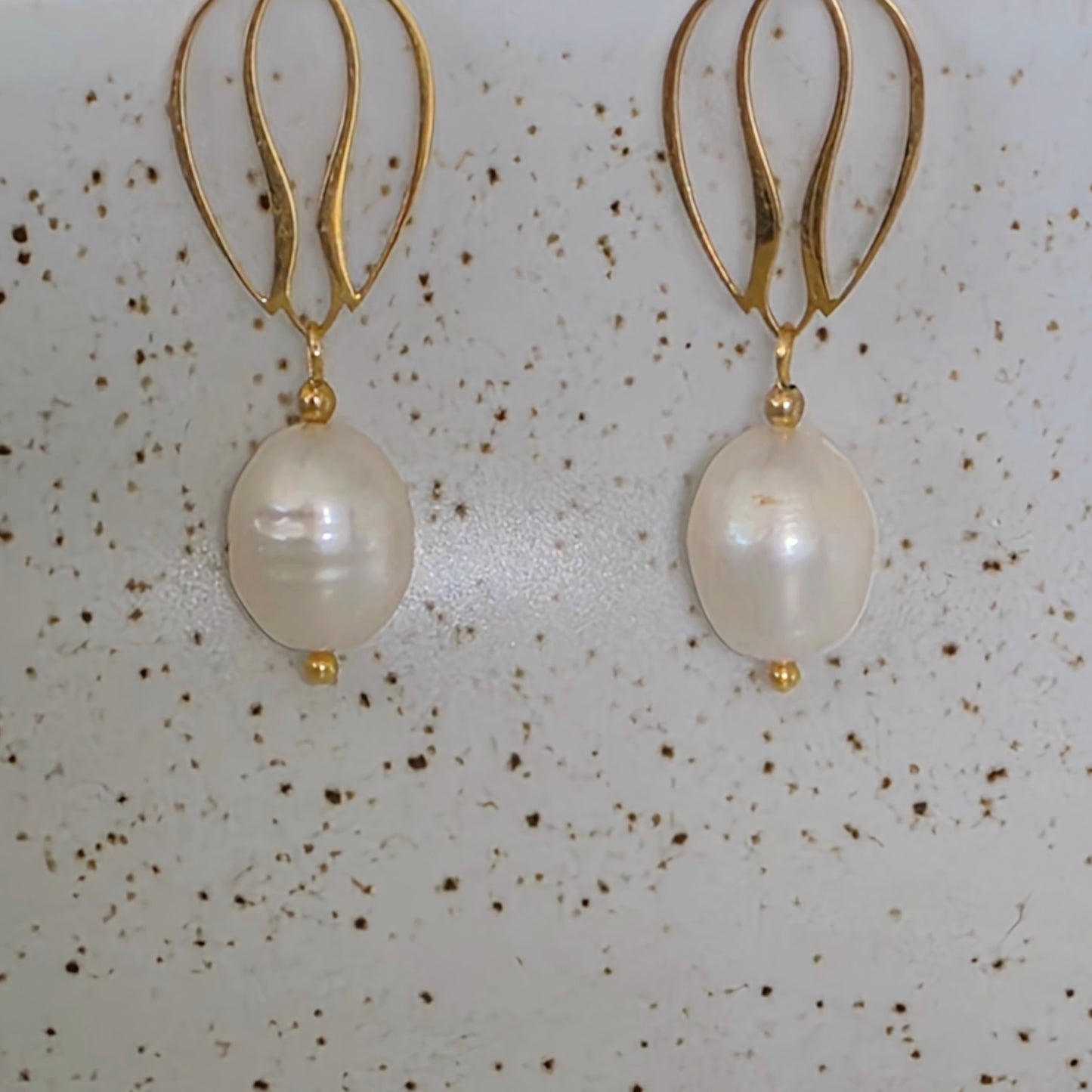 Close up view of the Dew handmade pearl earrings showing the luminous glow and uniquely shaped pearls