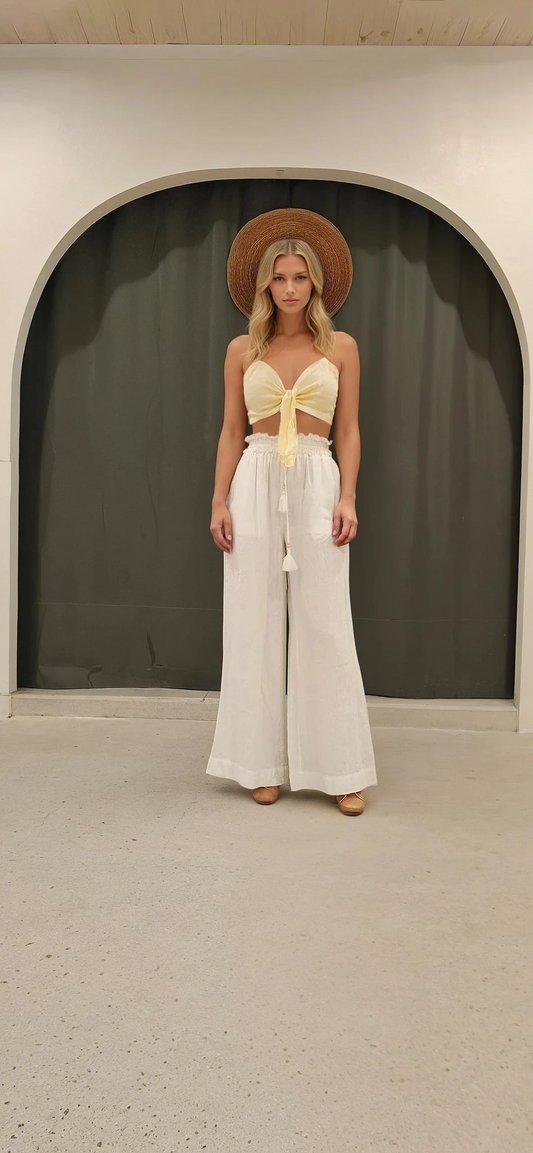 Front view of Faithfull the Label Garnier Top in yellow gingham with spaghetti straps and tie front.