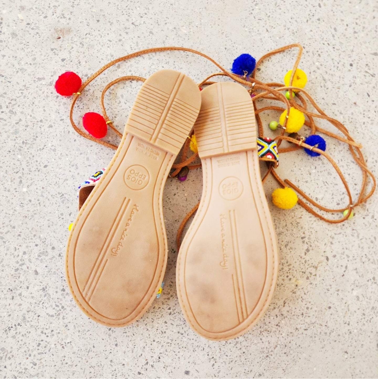 Gioseppo Omahas sandal whowing slight wear on sole traed and colourful pompoms, beading  details and lace-up ankle strap.