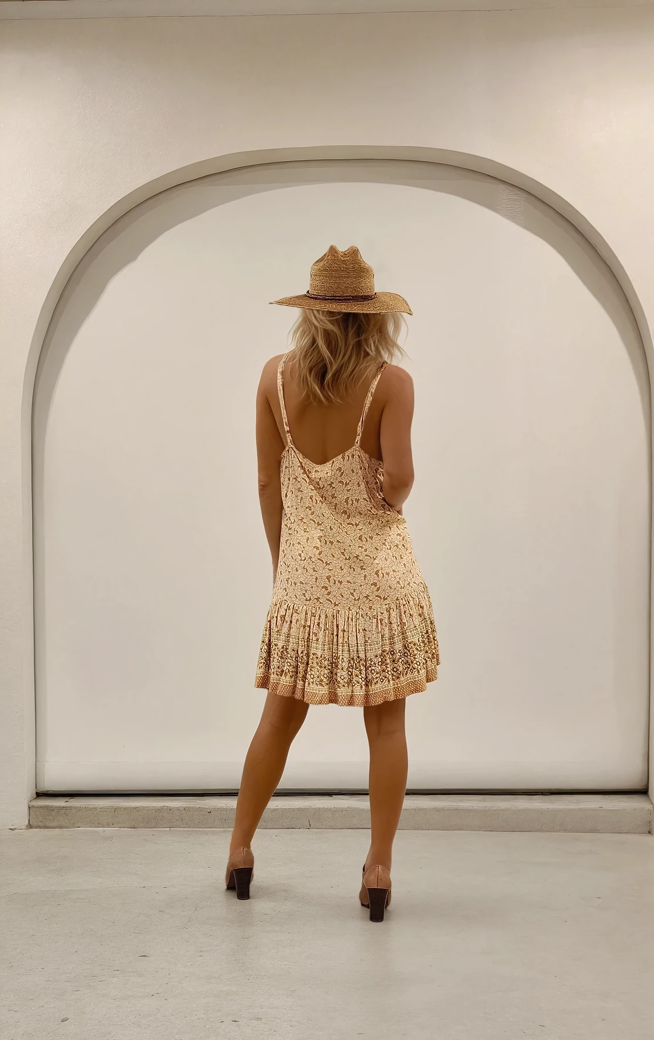 Back view of the Love St. ruffle mini dress, highlighting the relaxed back and flared skirt design.