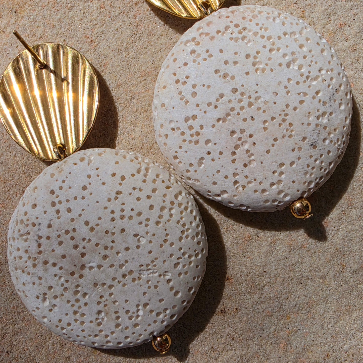 Close up view of the Relic Lumen earrings showing the discolouration from age.