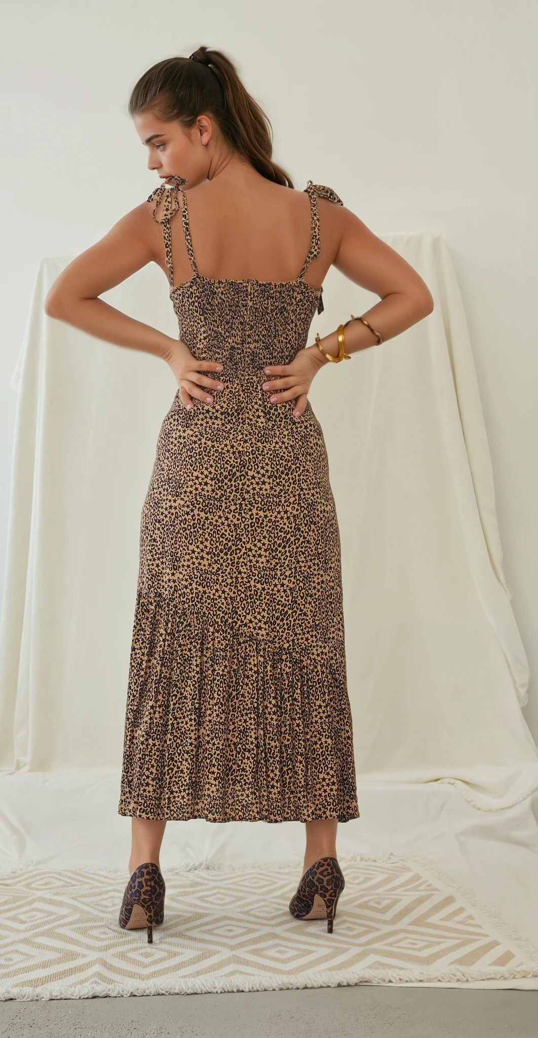 Back view of the Violet midi dress by Rue Stiic, showing ruched elasticated panel and zipper closure.