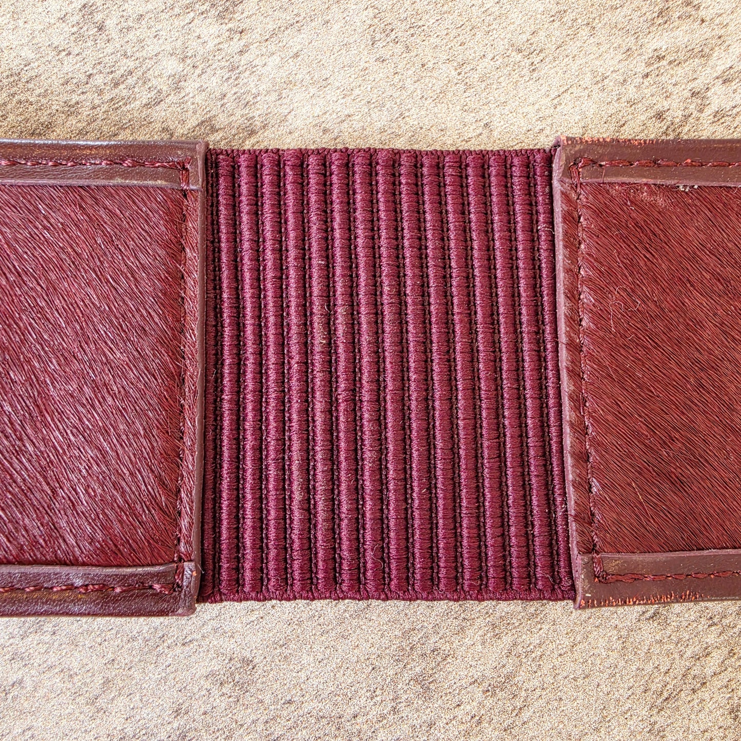 Back view of the inside of the Sass & Bide western style belt, showing the outside back stretch panel. This image also shows the imperfections on the leather near the stitching.