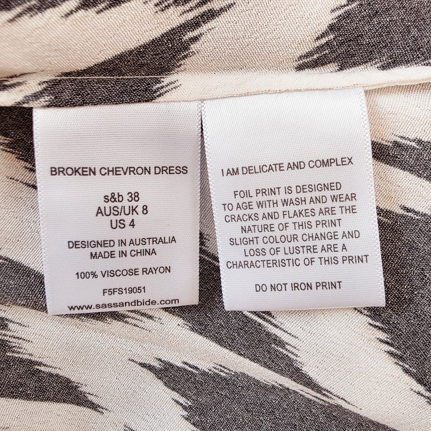 Style and care label inside the Sass & Bide Broken Chevron Dress showing the garment name, size AU 8 and fabric composition.
