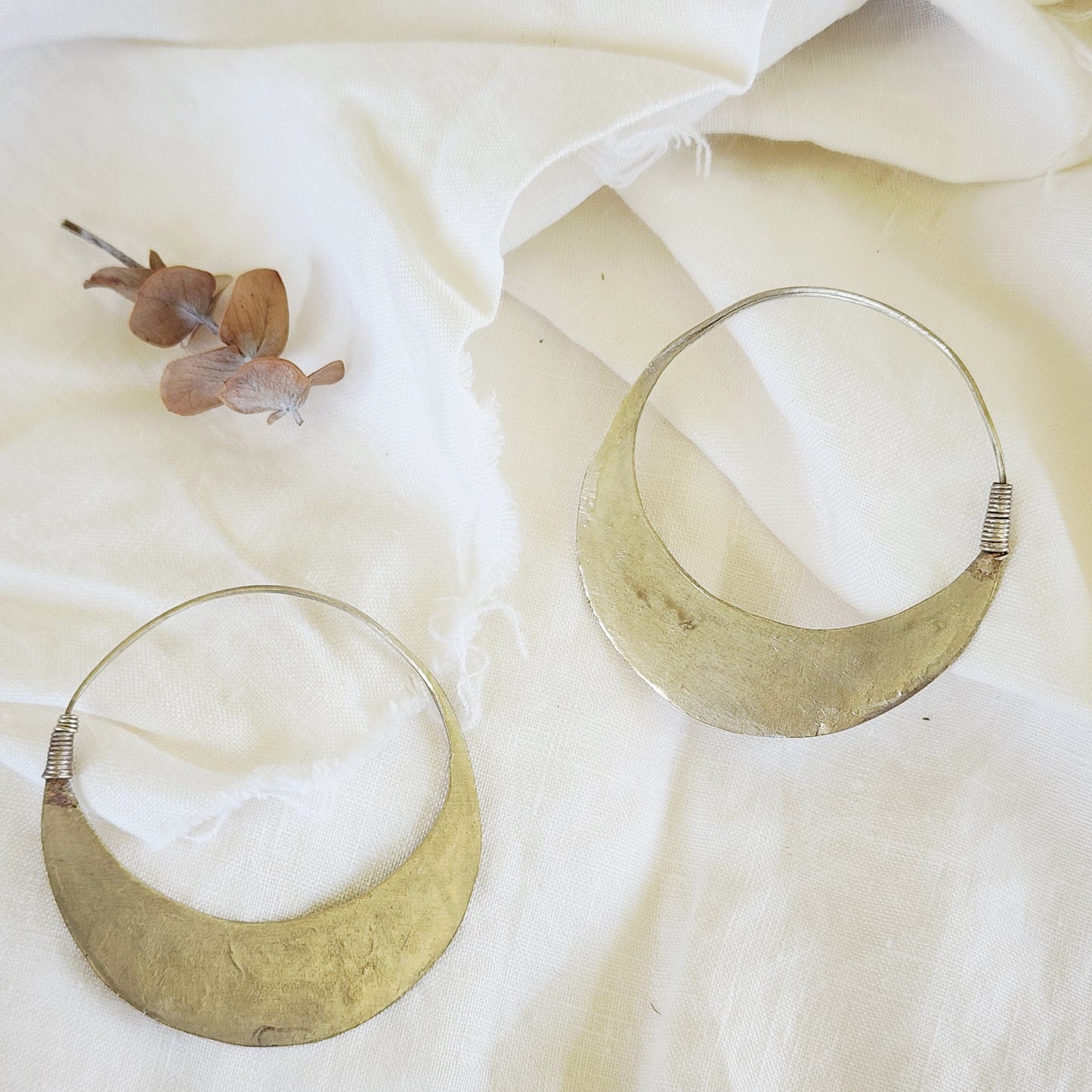 Back view of the Silver Strays etched crescent hoops, showing the clasp and desert-worn patina.