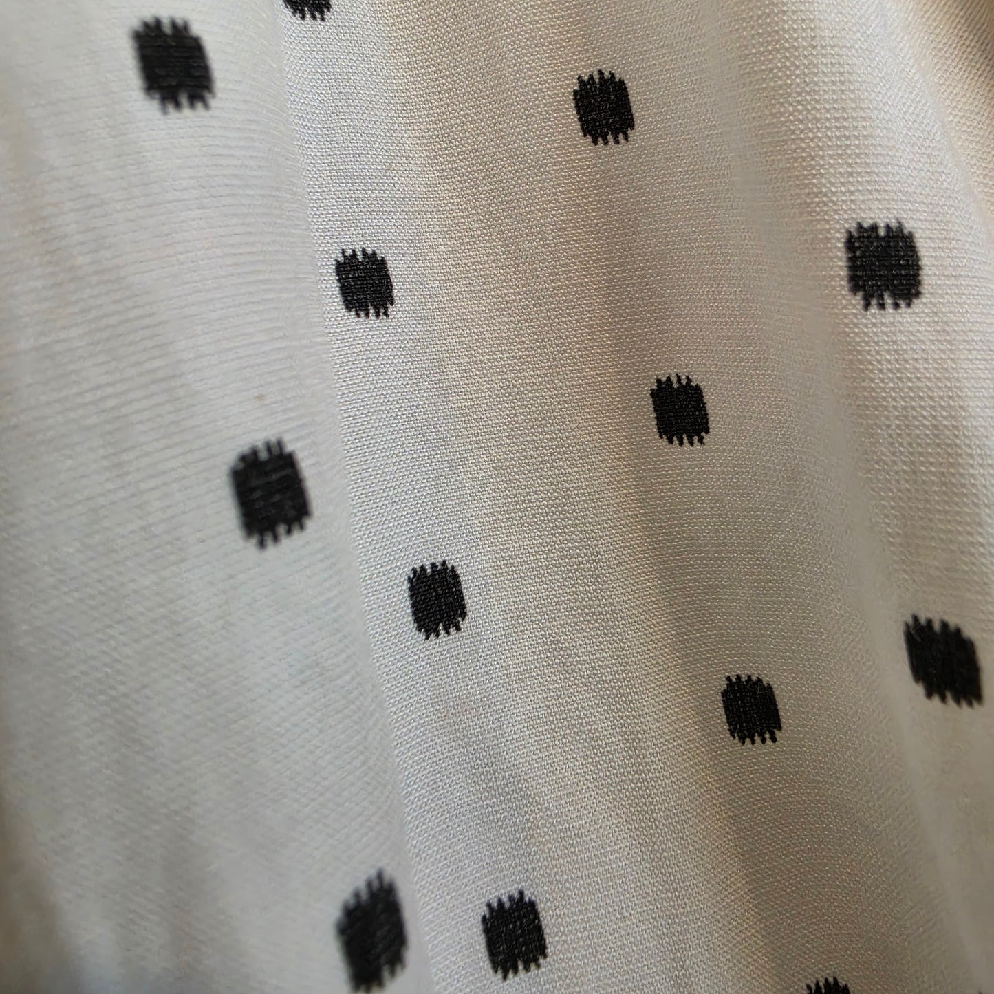 Close up view of the polka dot details on the Maya playsuit by St Marlo
