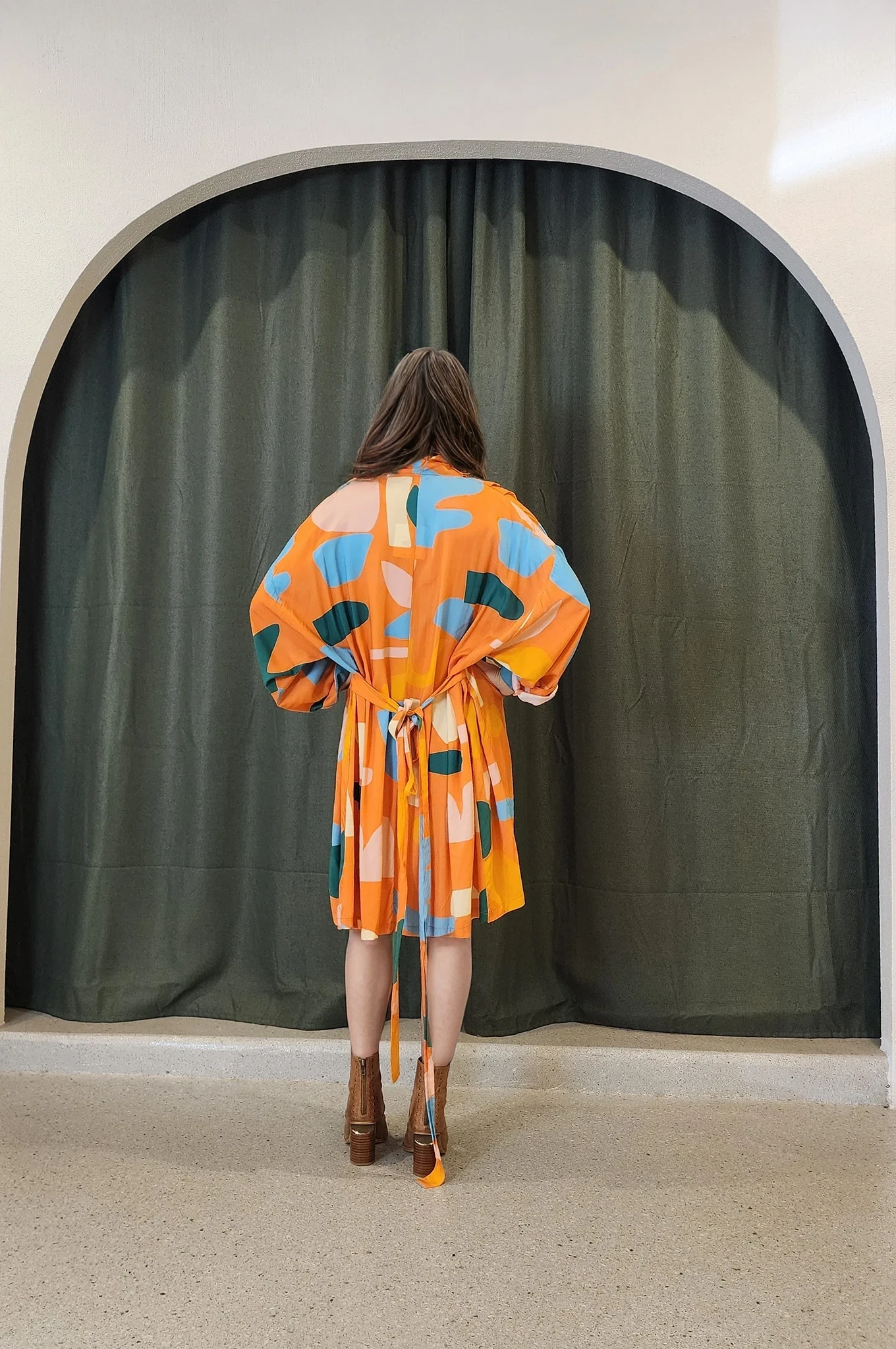 Back view of the dress showing the relaxed fit and floaty hemline. The print continues throughout and tie belt can be seen from behind, offering an effortless look from all angles.