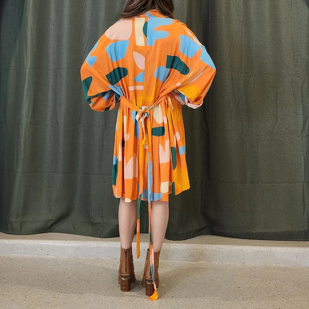 Back view of the dress showing the relaxed fit and floaty hemline. The print continues throughout and tie belt can be seen from behind, offering an effortless look from all angles.