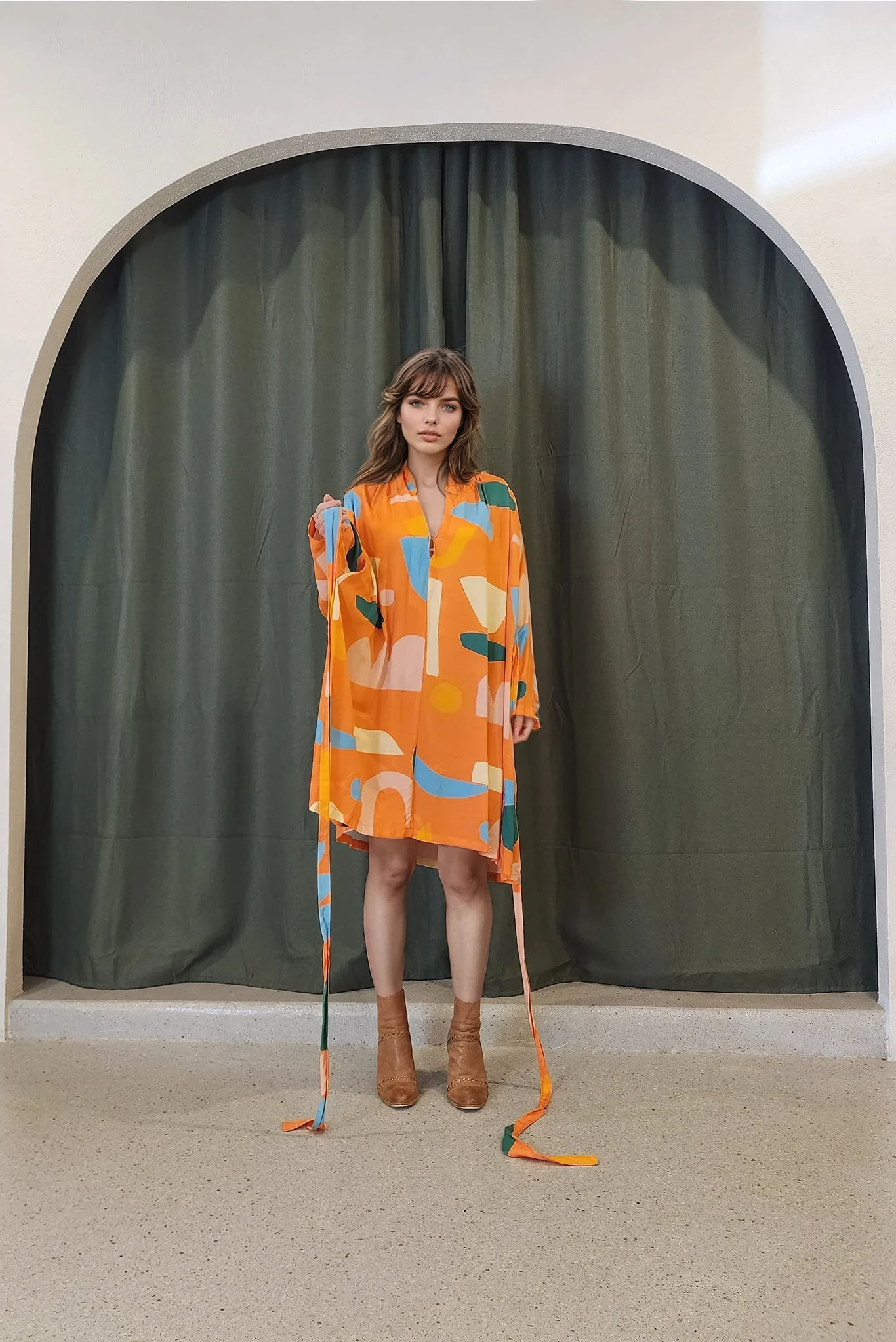 Front angle of the vintage-inspired dress, untied, highlighting the soft drape and cut. Fabric moves fluidly with the body, showcasing its airy, summer-ready construction and attached tie belt.