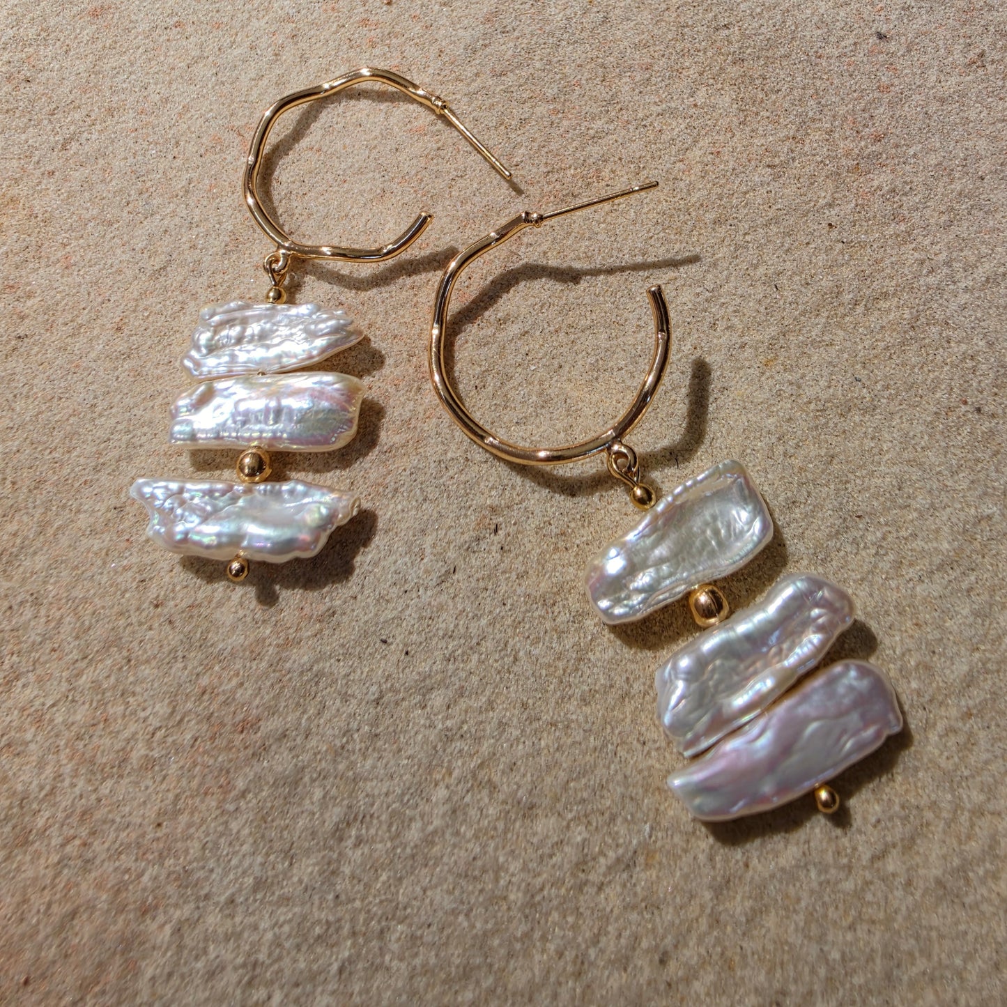 Back view of the Tide handmade pearl earrings, showing the bright sheen and irregular shape of the pearls.