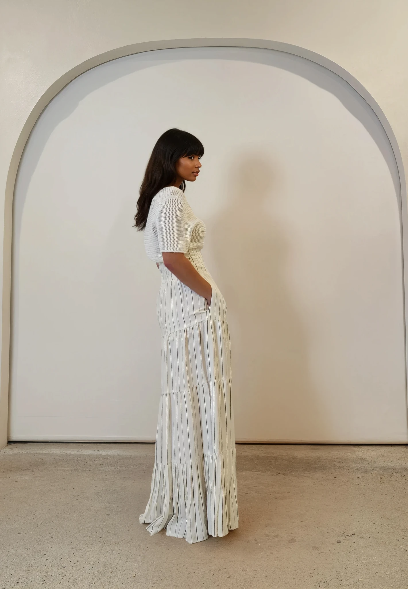 Profile view showing skirt's flattering shape and pocket detail.