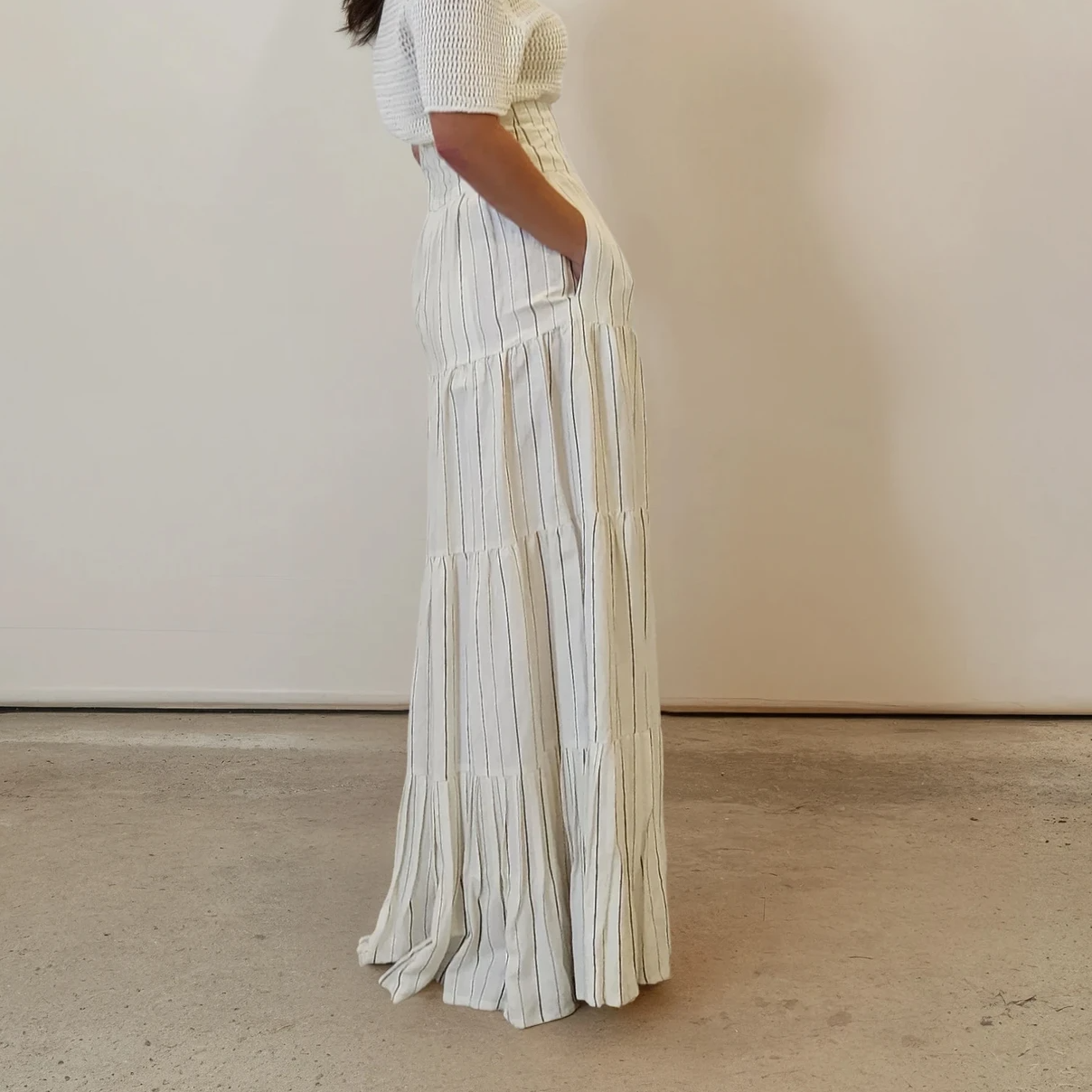 Profile view showing skirt's flattering shape and pocket detail.
