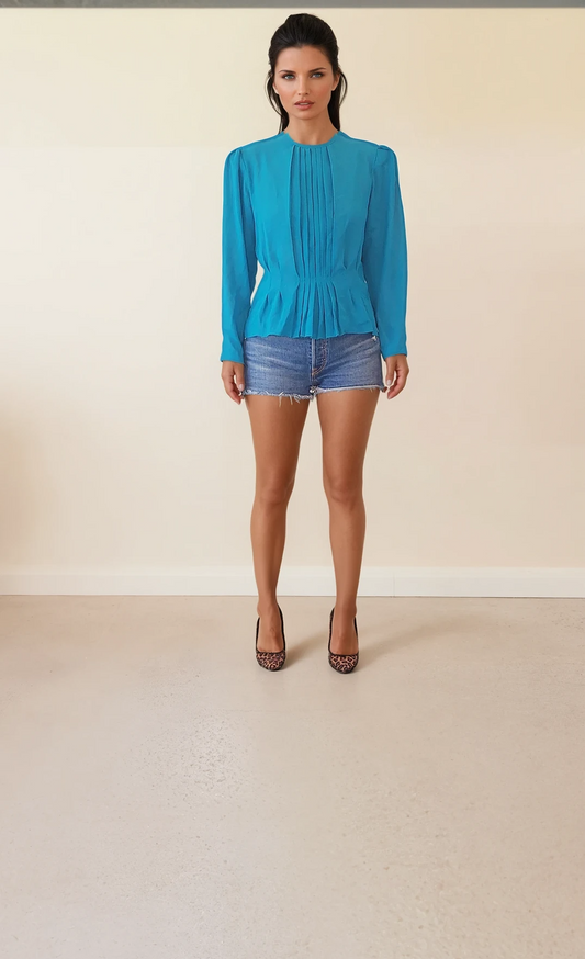 Front view of long sleeve vintage blouse in size 10 featuring shoulder pads, pleated details, and peplum-style waist.