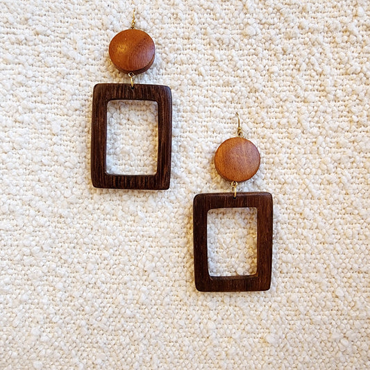 Wilson Avenue wooden earrings with square frames and round wooden beads on a textured beige surface