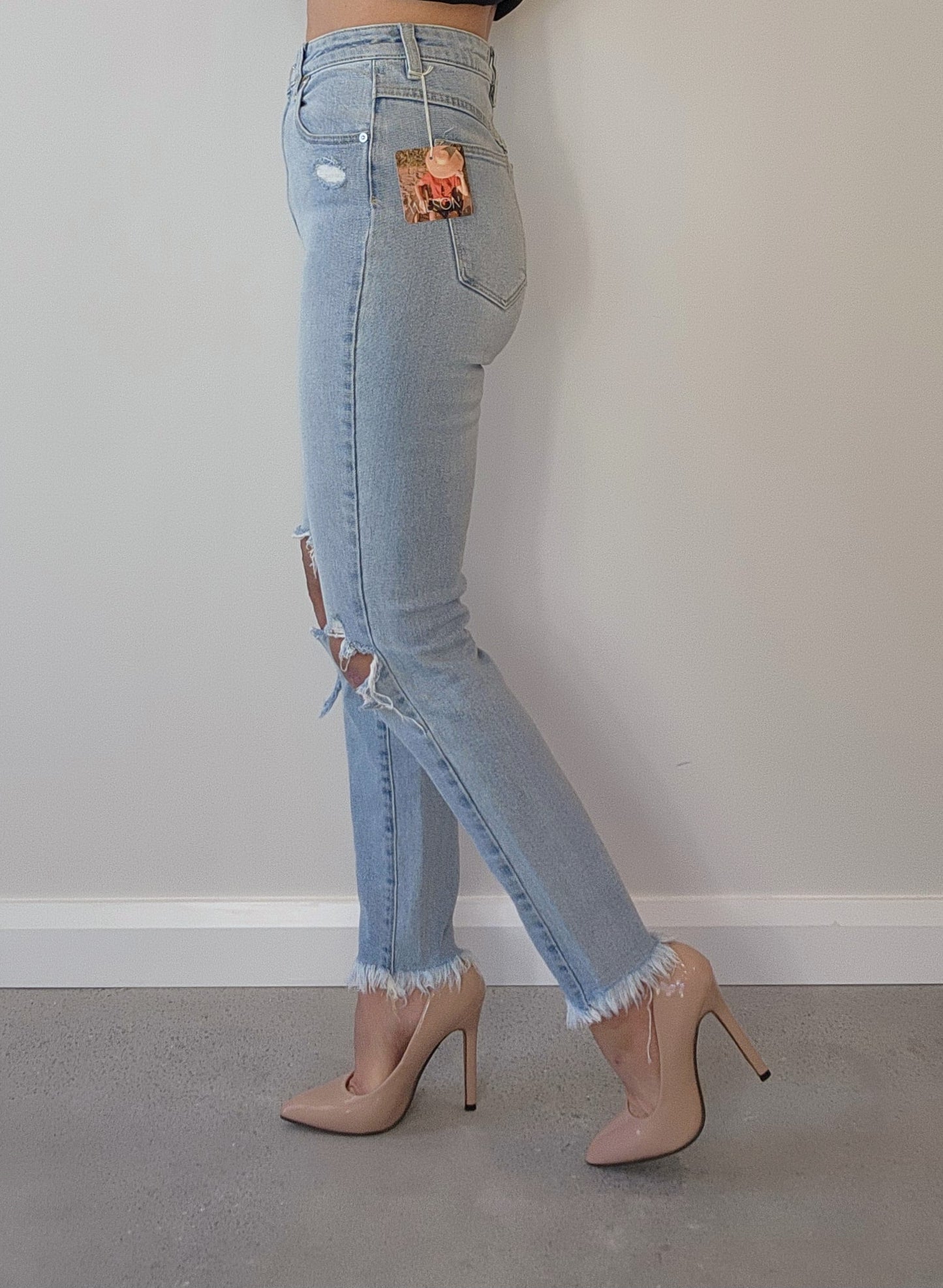 Light wash, high waisted Abrand skinny jeans, raw hem, size 9