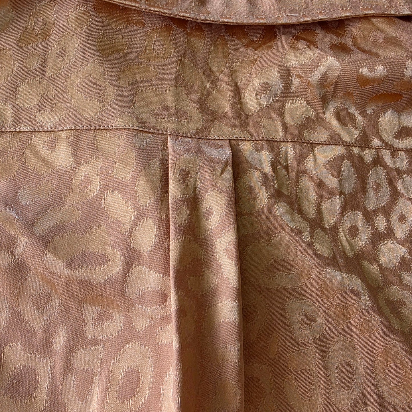 View of the back detail showing the shiny animal print and pleat detail on the ACOA retro button up shirt.