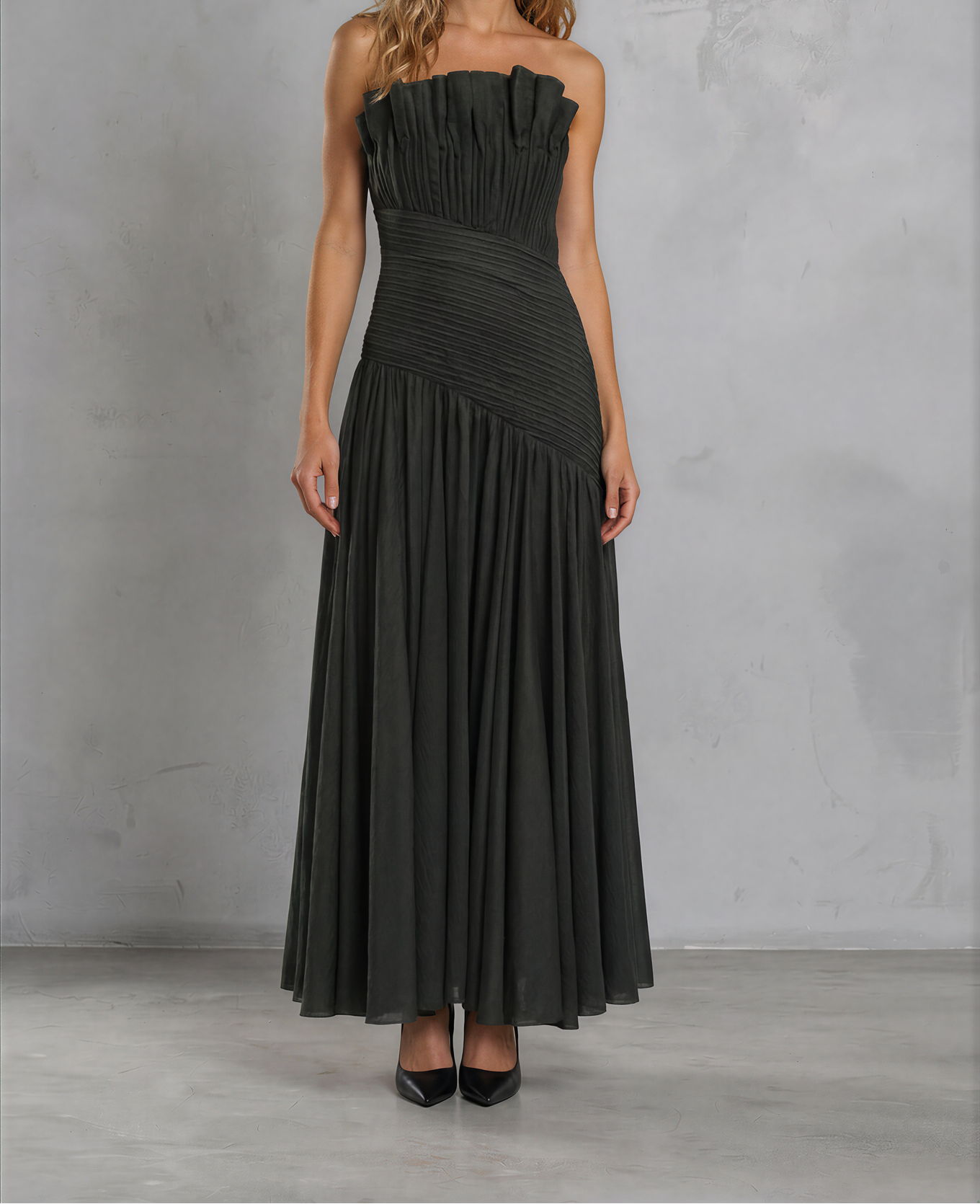 Front view of model wearing the Aje Aquiline Gown showing the pleated details and sculptured neckline.